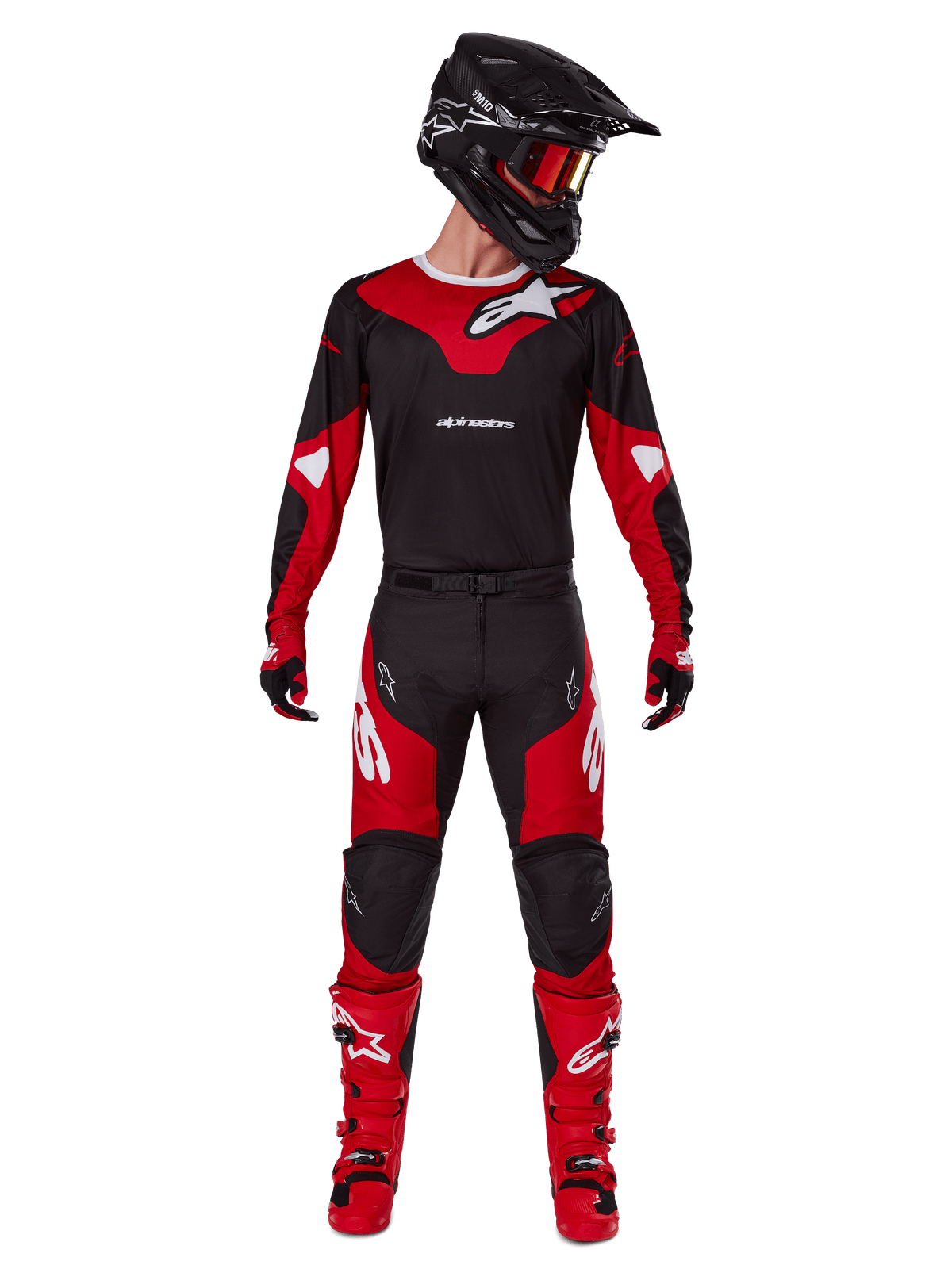 Motocross rider wearing the Alpinestars 2025 Racer Veil gear set, Black and Bright Red jersey with white Alpinestars logo, matching motocross pants, black helmet with red goggles, and red boots, complete performance outfit for off-road riding