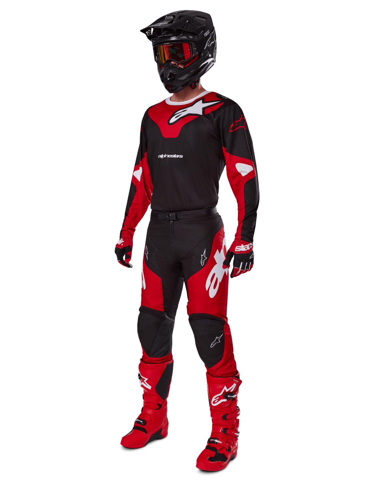 Motocross rider wearing complete racing gear featuring the Alpinestars 2025 Racer Veil Jersey in Black and Bright Red, matching pants, red boots, black helmet with red goggles, and red and black gloves, coordinated performance look for off-road racing