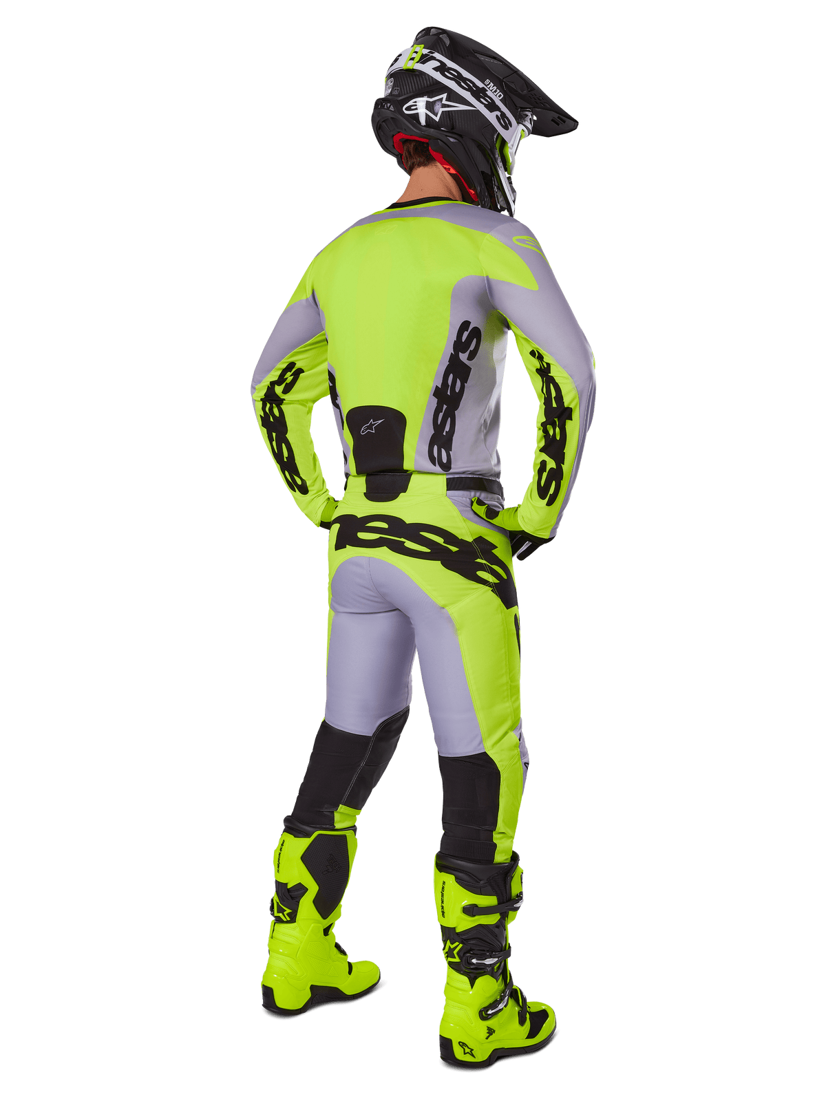 Motocross rider from behind wearing Alpinestars 2025 Racer Veil Gear Set, Gray and Yellow Fluo jersey and pants, matching fluo yellow boots and black and yellow helmet, coordinated outfit for off-road racing