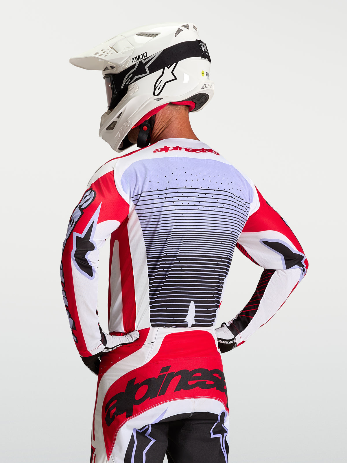 Alpinestars Techstar Maven tröja, röd och vit motocrosströja för herrar, laserskuren ventilation, sedd bakifrån.