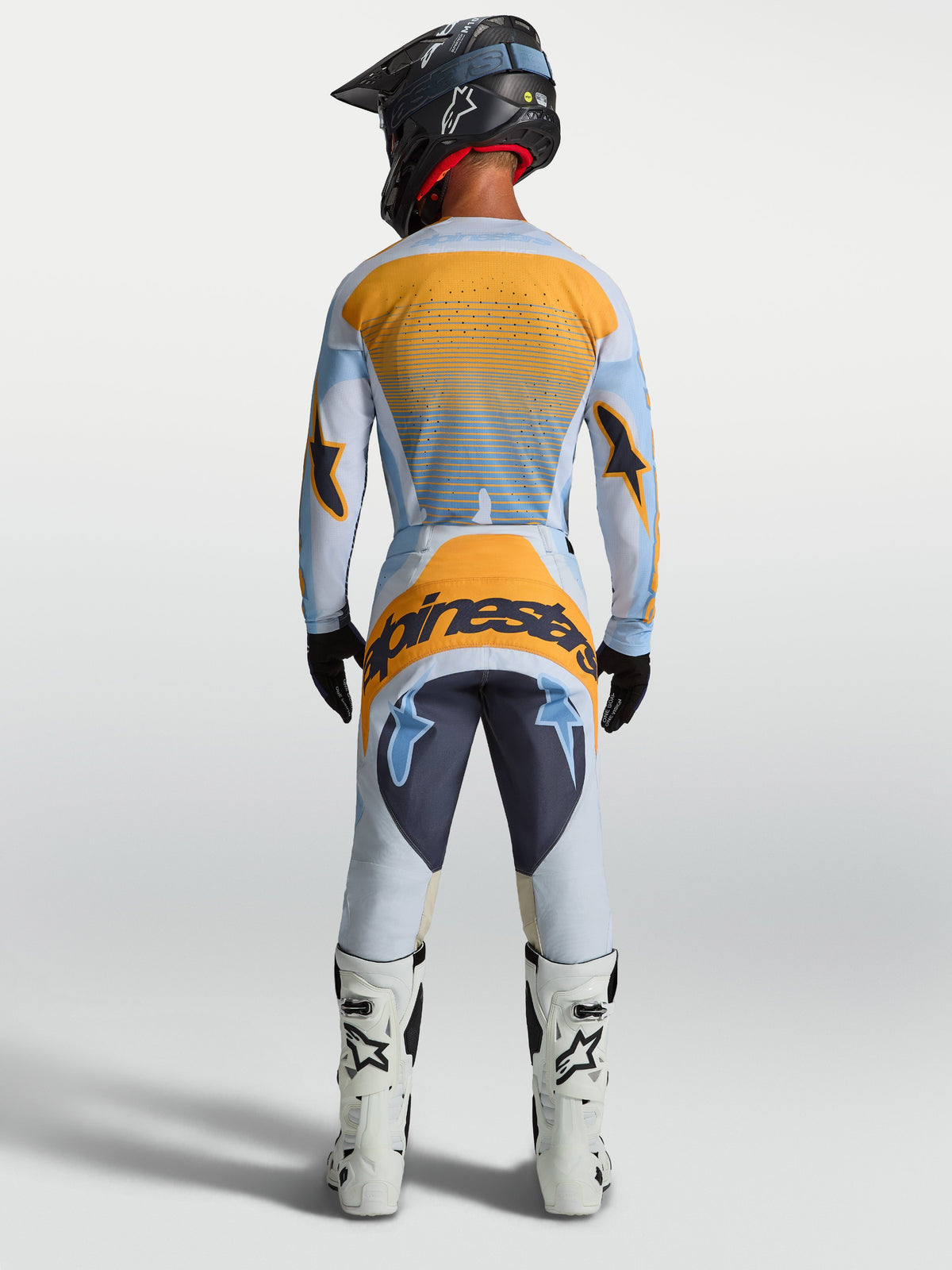 Alpinestars Techstar Maven tröja och gear set, motocrossracing för herr, ljusblå och orange, vy bakifrån.