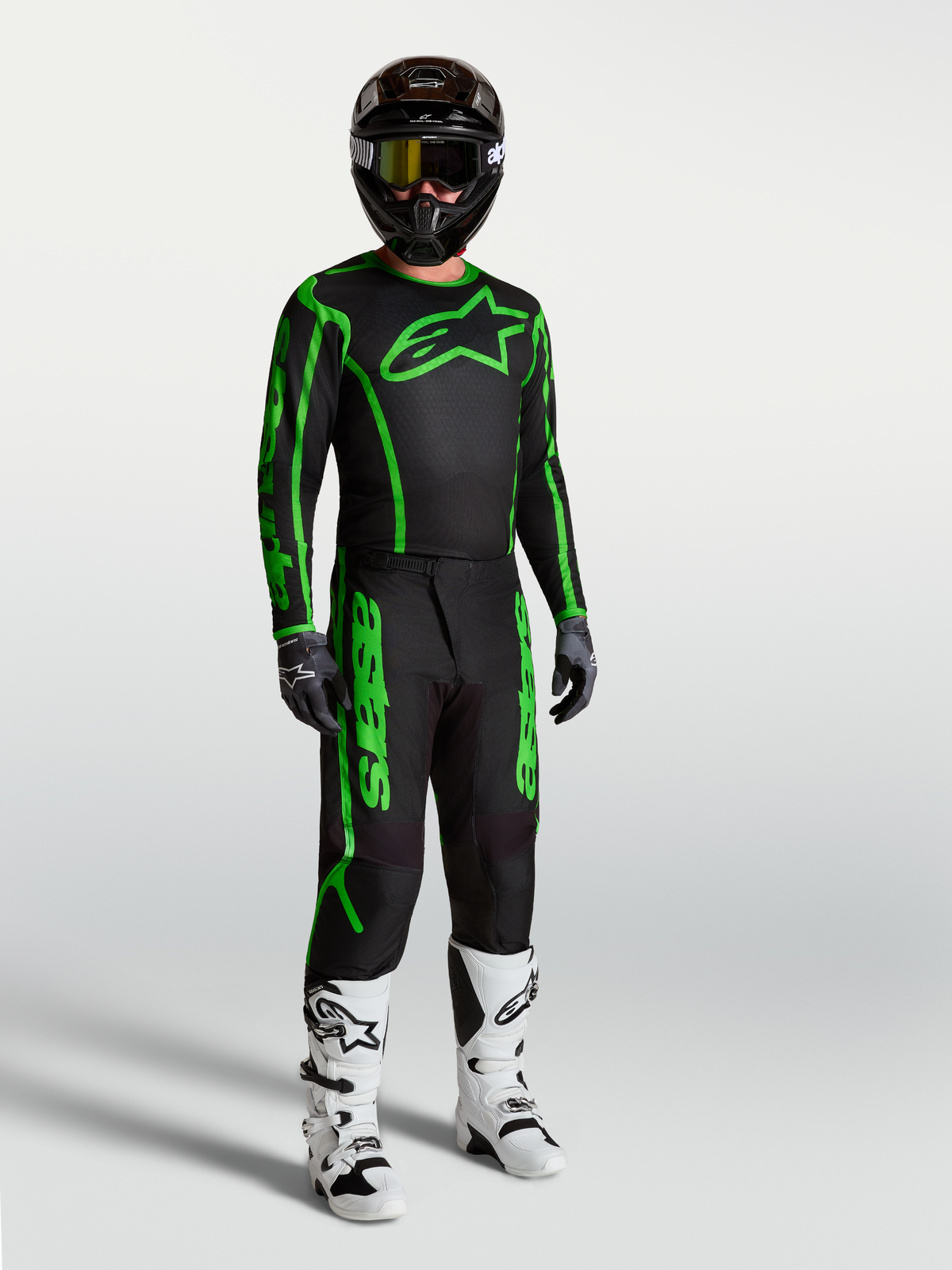 Alpinestars Fluid Apex V2 tröja, motocrossutrustning för herr, svart och neongrön, modell med matchande byxor och stövlar.
