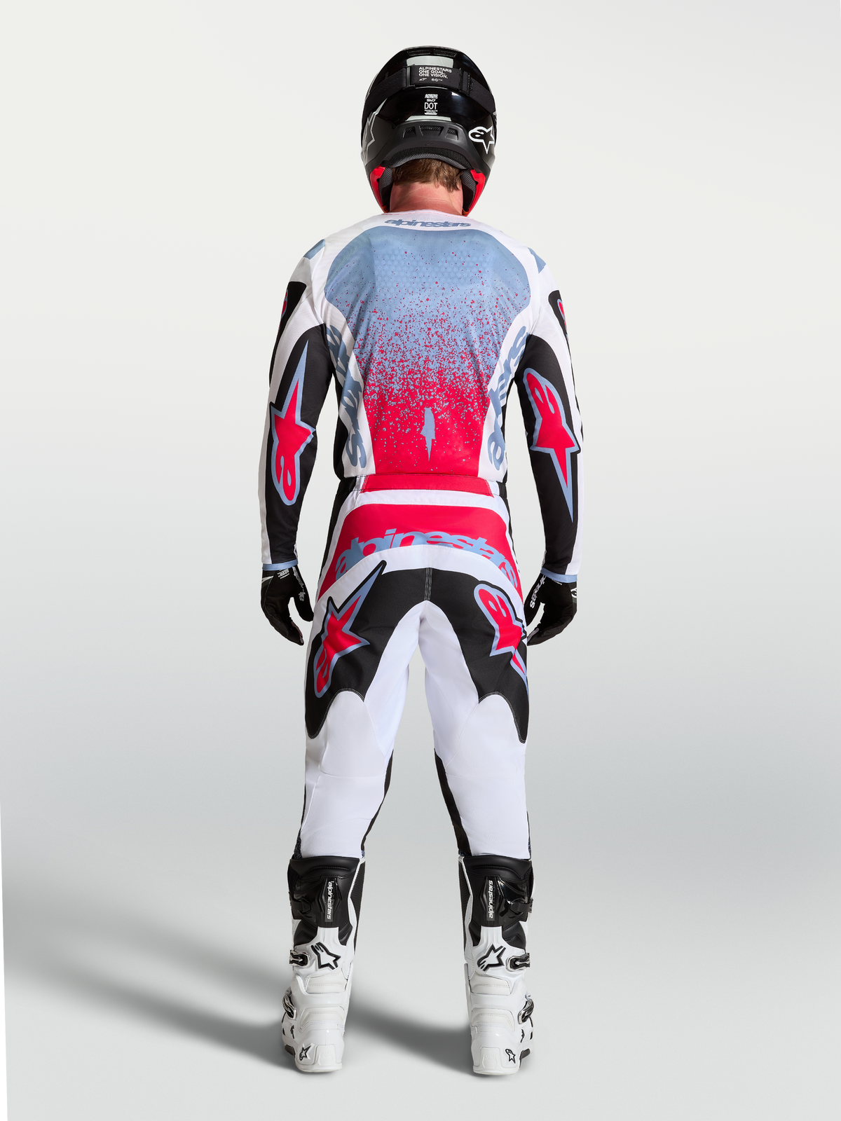 Alpinestars Fluid Drag Jersey, Men's Motocross Racing Jersey in Black and Red Fluo, shown from a rear view on a rider.
