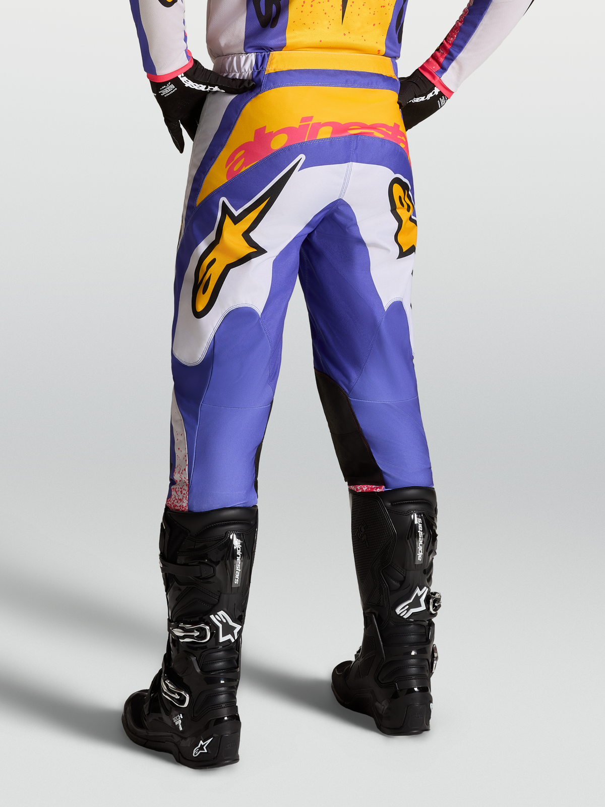 Alpinestars Fluid Drag Pants, Motocross Racing Pants in Blue and Gold, featuring pre-curved legs and reinforced back yoke.