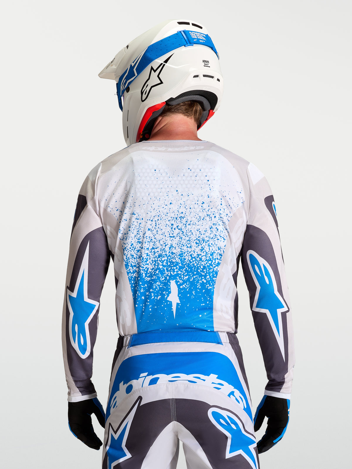 Alpinestars Fluid Drag Jersey, breathable men's motocross gear in Graystone and Blue shown from a rear view.