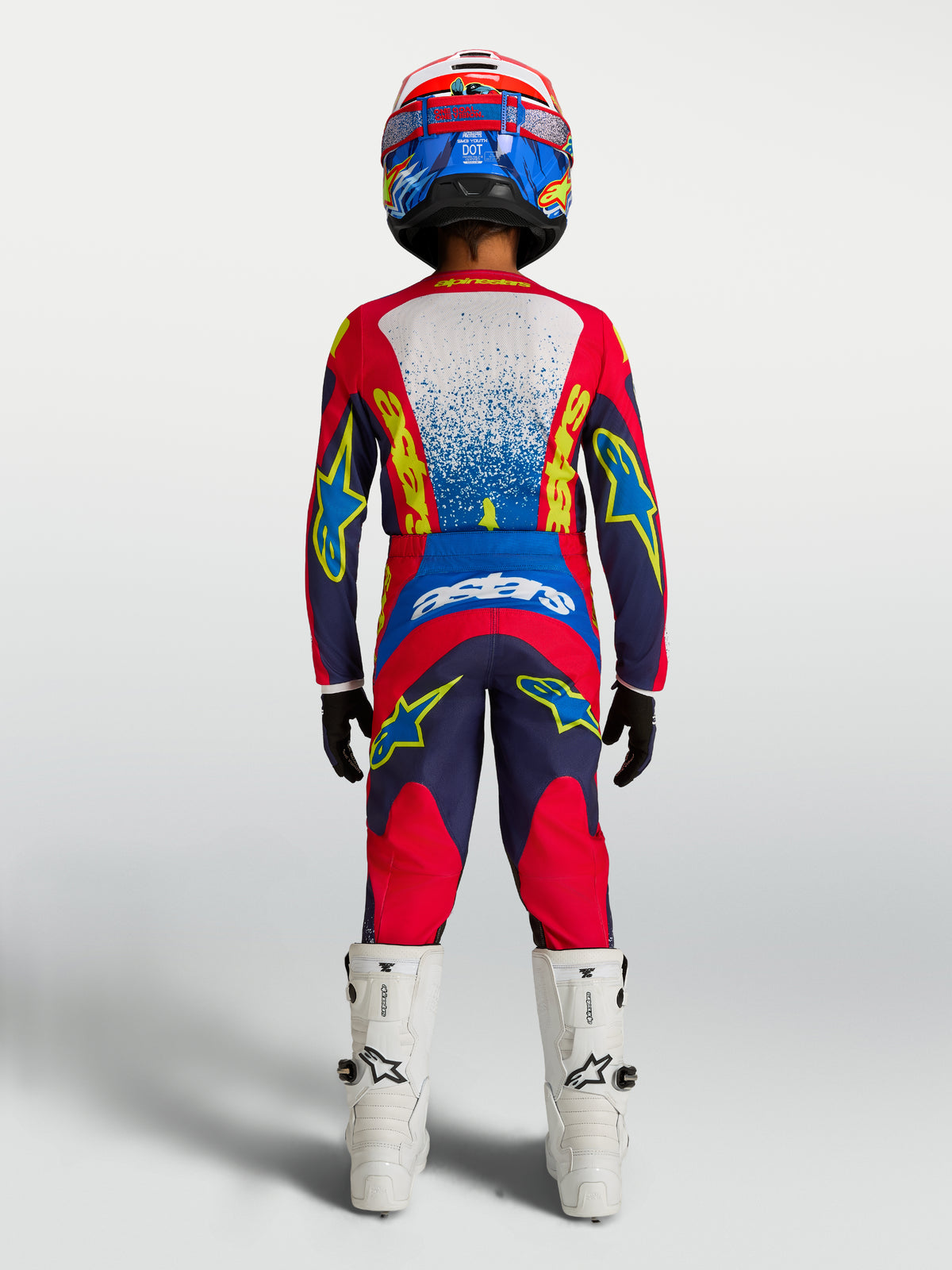 Alpinestars 2027 Fluid Drag ungdomströja och utrustningsset, marinblå och röd motocrossutrustning, vy bakifrån på förare.