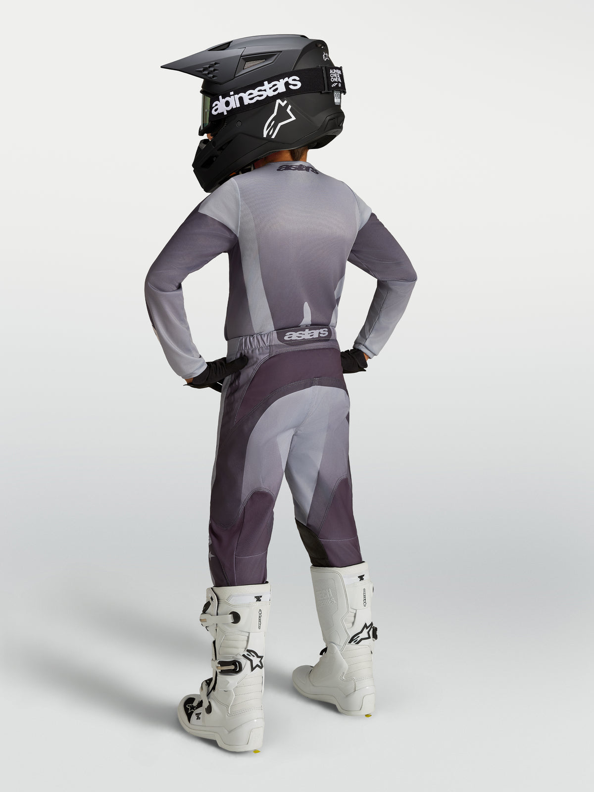 Alpinestars 2027 Youth Fluid Amber Gear Set, gray and purple youth motocross outfit with helmet and white boots.