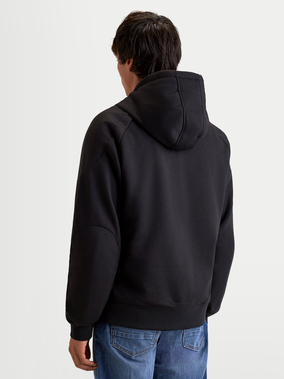 Alpinestars Ageless Hoodie, men's urban motorcycle hoodie in black, rear view on a model showing the fixed hood and casual textile construction