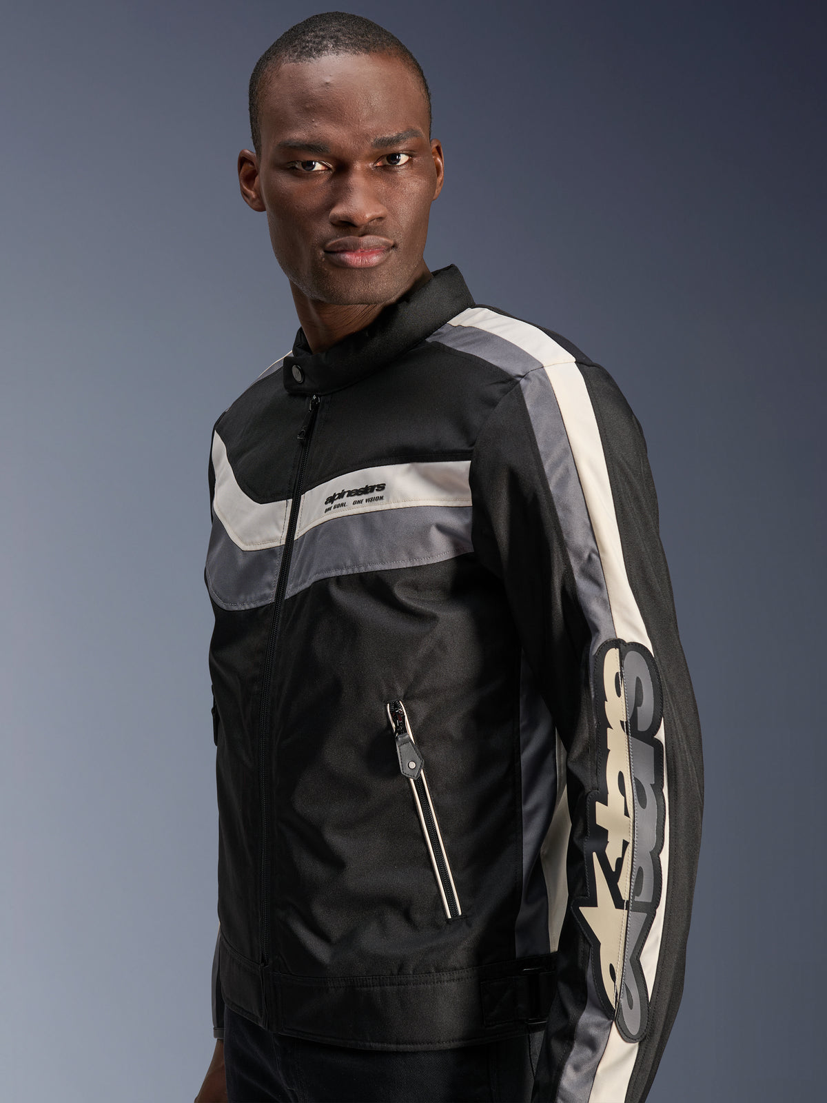 Alpinestars T-Dyno WR Jacket, Black Dark Gray and Ecru, vintage-inspired textile motorcycle jacket with horizontal chest stripes, large vertical branding on the sleeve, and zippered front pockets, urban road gear