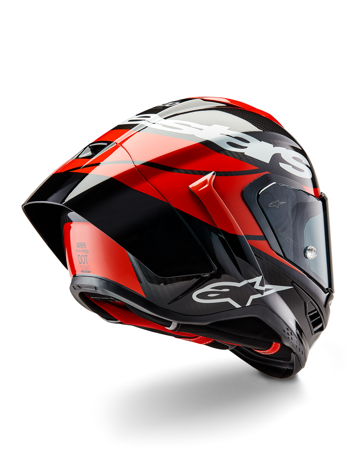 Alpinestars Supertech R10 Element hjälm, svart kolfiber, ljusröd och vit blank, trekvartsvy bakifrån som visar stor aerodynamisk spoiler och kolfiberskal, med tydliga Alpinestars-logotyper och DOT-certifiering