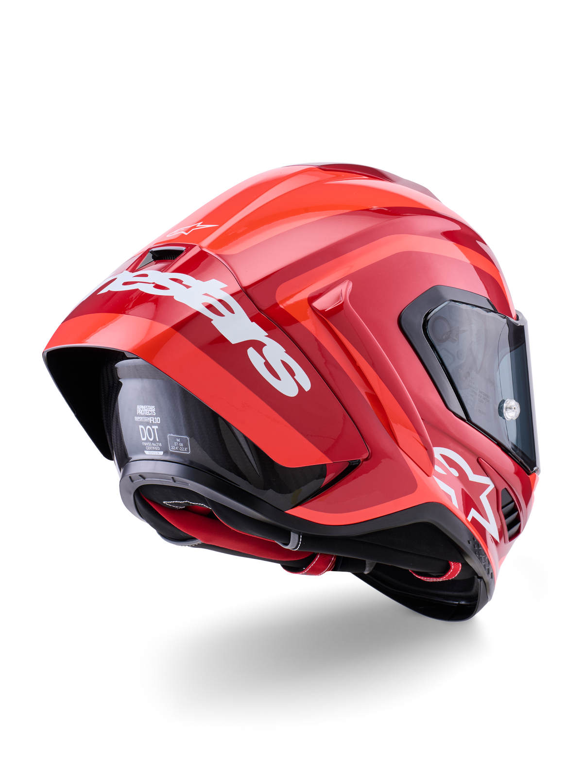Alpinestars Supertech R10 Arius hjälm, blankröd med vit logotyp, vy snett bakifrån som visar aerodynamisk spoiler, kolfiberskalskonstruktion och strömlinjeformad racingprofil med mörkt visir