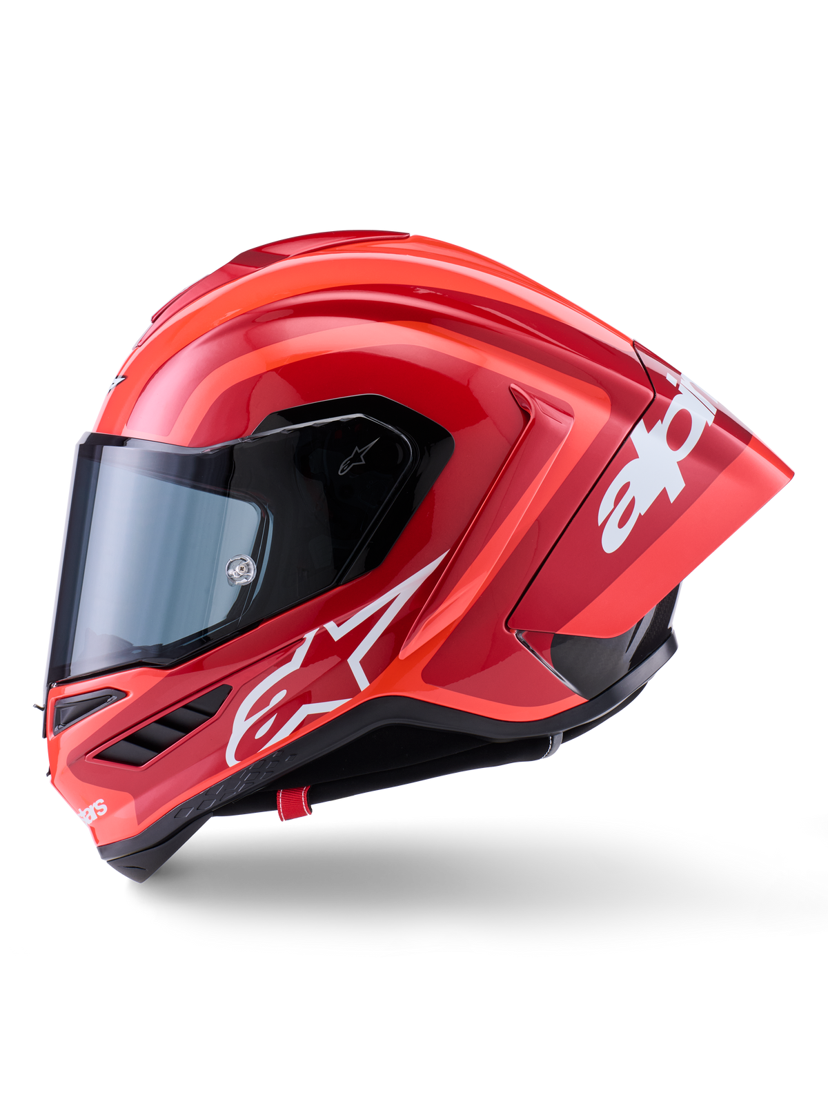 Alpinestars Supertech R10 Arius-hjälm, integralhjälm för racing, glansig röd med vit logotypgrafik, sidoprofilvy som framhäver den aerodynamiska spoilern och det klara visiret, kolfiberkompositskal för professionell motorsport