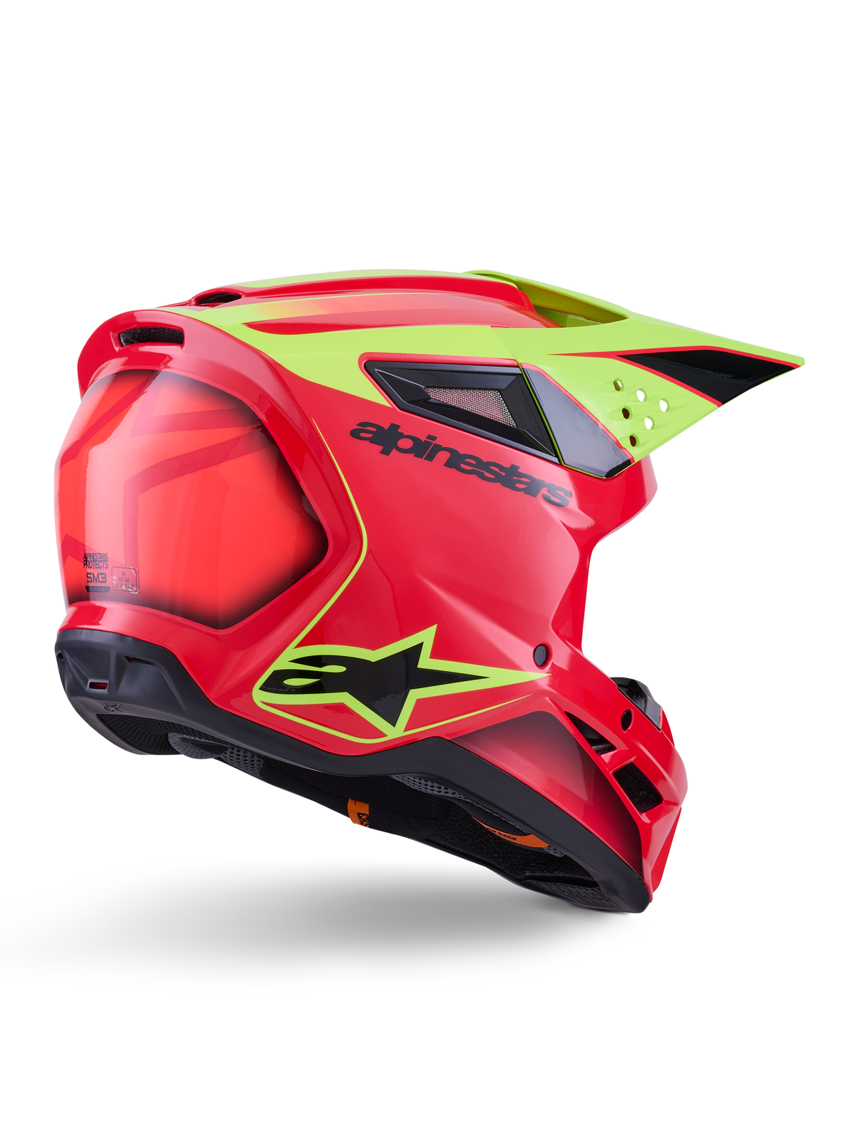Alpinestars S-M3 Fray-hjälm ECE 22.06, motocrosshjälm, röd, neongul och blanksvart, vy snett bakifrån som visar det smidiga aerodynamiska skalet med flera ventilationsöppningar, neongul grafik och tydlig svart Alpinestars-logotyp.
