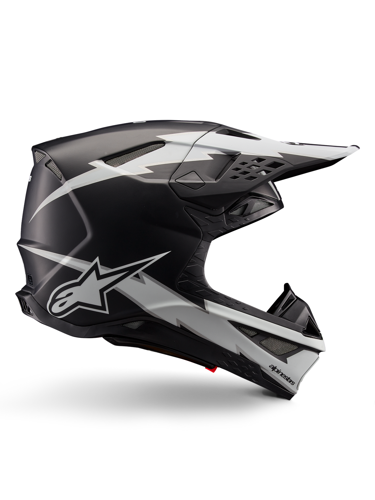 Alpinestars Supertech M10 Ampress Helmet, Motocross Racing Helmet, Black and White Matte, aerodynamic profile with white lightning bolt graphics, multiple air vents, extended sun visor, carbon fiber construction with matte finish