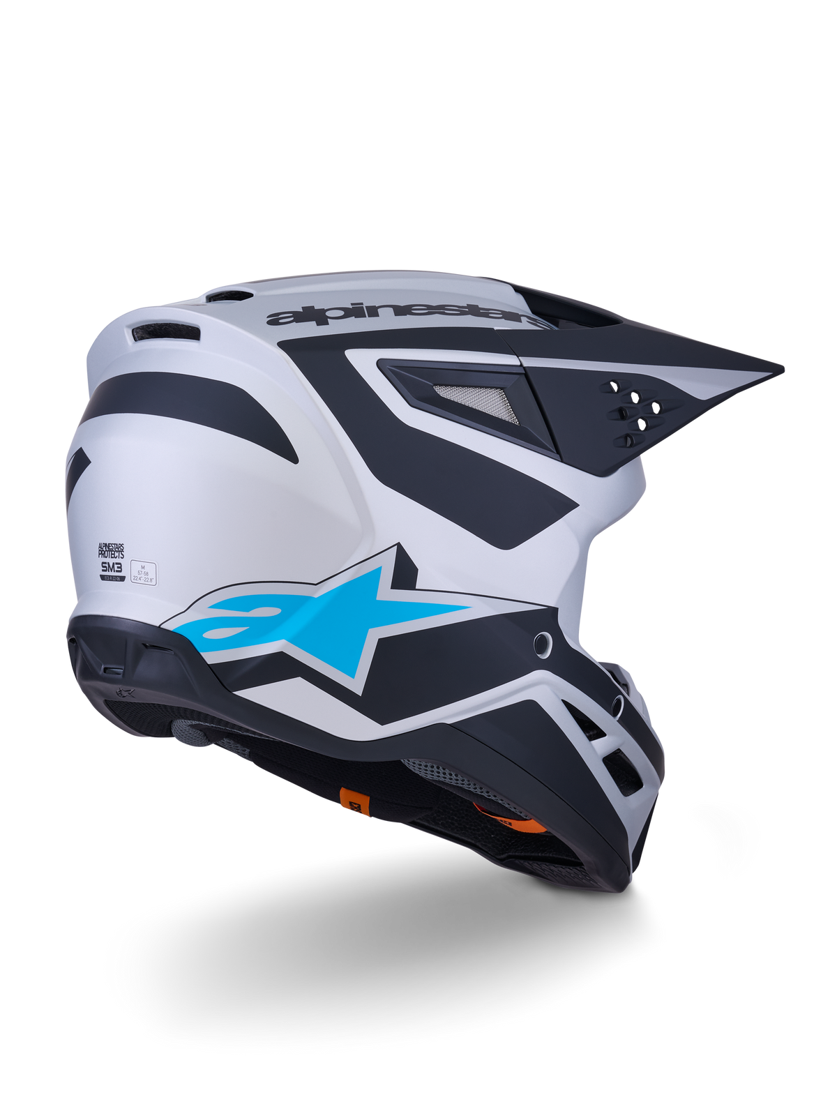 Alpinestars S-M3 Heat-hjälm ECE 22.06, motocrosshjälm, silver, blå och matt svart, vy bakifrån med stor blå stjärnlogotyp och svarta vinklade mönster, aerodynamiskt skal med ventilationsöppningar, högpresterande skydd för terrängkörning