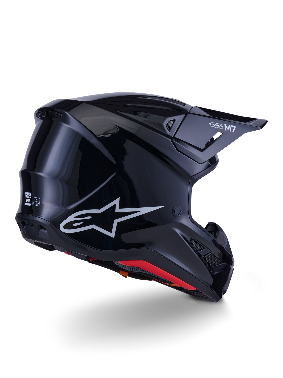 Alpinestars S-M7 Solid-hjälm, motocrosshjälm, blanksvart med ett strömlinjeformat aerodynamiskt skal, silverfärgad Astars-logotyp, röd innerkant och integrerade ventilationsportar, designad för skydd vid terrängkörning