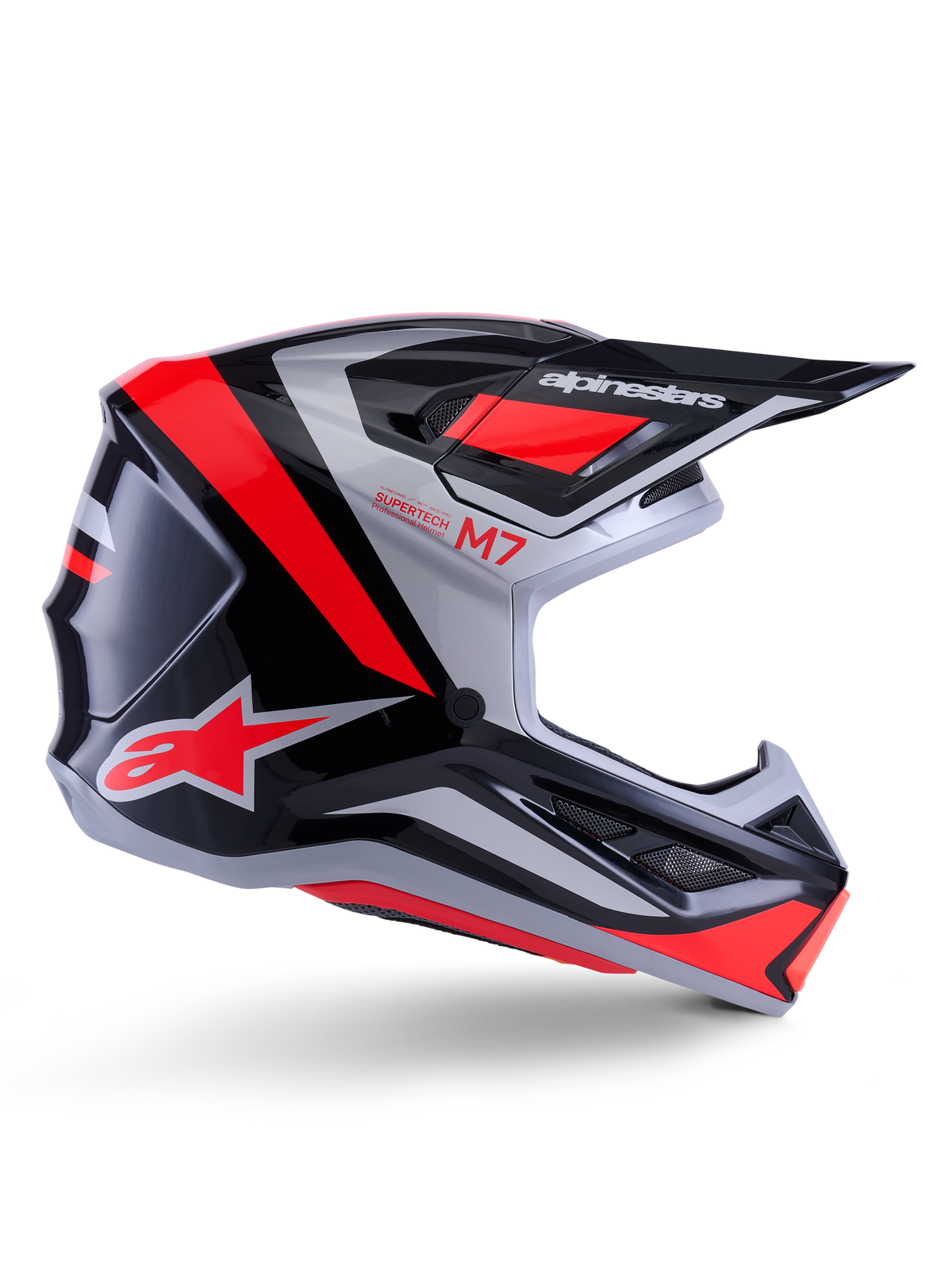 Alpinestars S-M7 Rise-hjälm, motocrosshjälm, svart, silver och röd fluo, sidovy som visar kantig aerodynamisk design med skärm och ventilationsöppningar, glansig finish, Supertech M7-serien