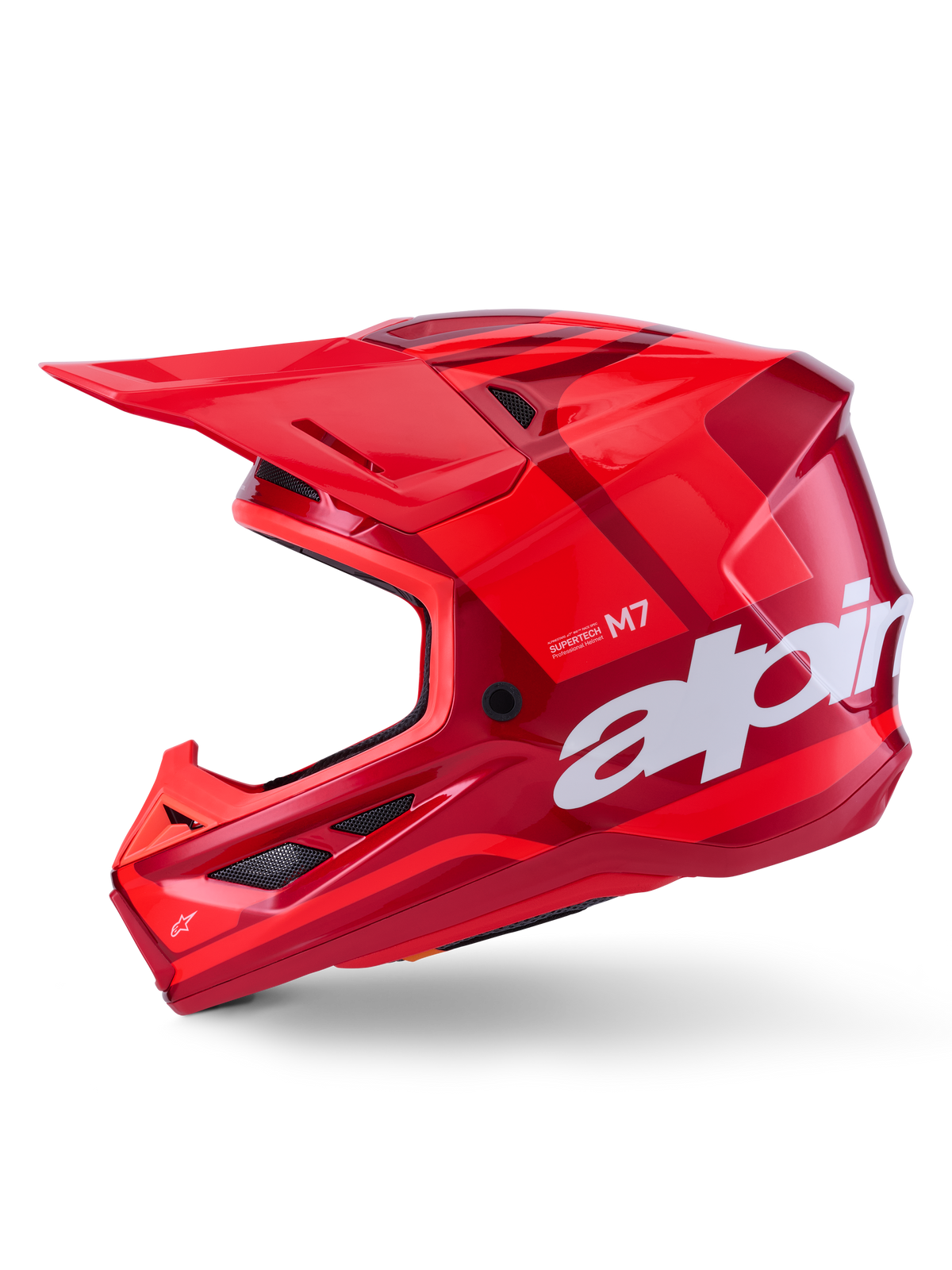 Alpinestars S-M7 Core hjälm, röd glansig med geometriska accenter, motocrosshjälm, sidoprofilvy, aerodynamiskt skal med ventilationsöppningar och vit logotyp, högpresterande utrustning för terrängkörning