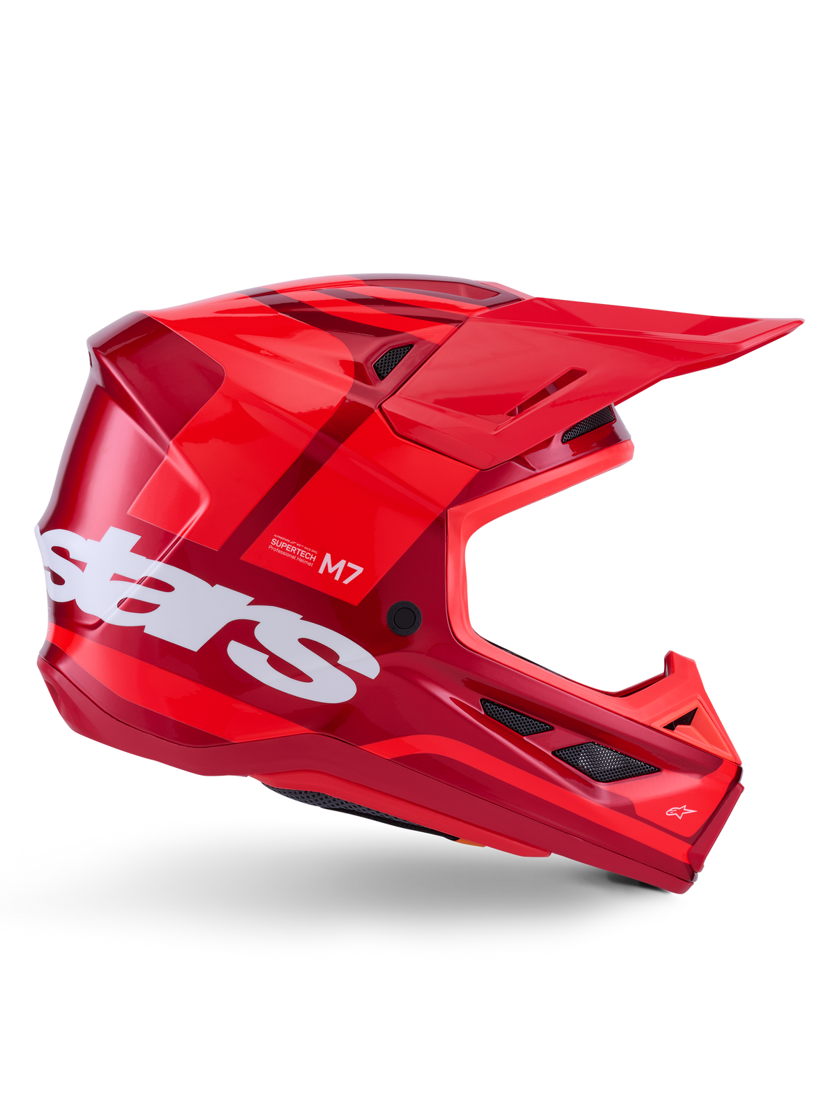 Alpinestars S-M7 Core-hjälm, motocrosshjälm, blank röd med mörkröda detaljer och vit logotyp, sidovy med en stor vit stars-logotyp, aerodynamiskt skal med ventilationsöppningar i nät och ett framträdande visir