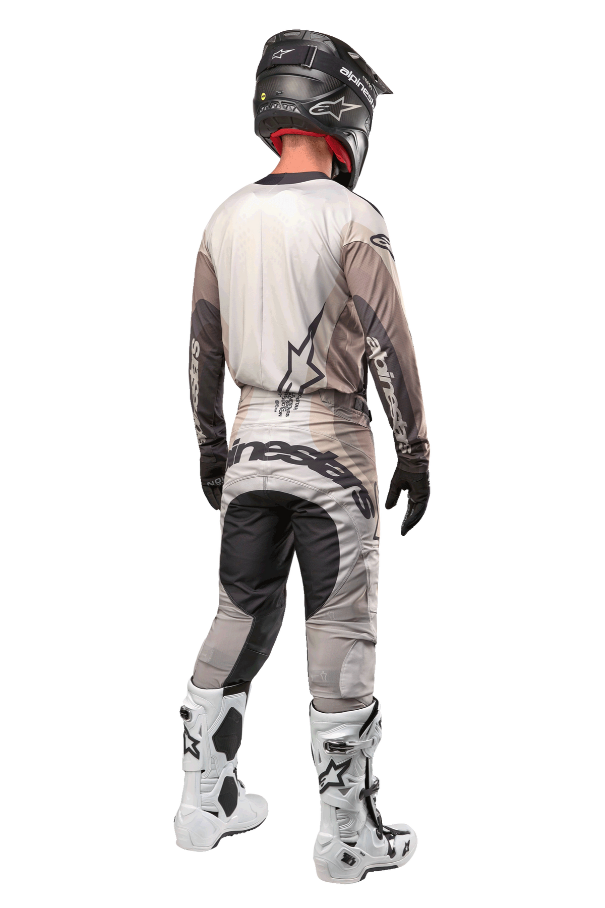 Alpinestars 2024 Techstar Pneuma Pants, Motocross Pants, Dark Sand and Iron Dust Gray, back view worn by a rider with a matching jersey, white and black boots, and a black helmet, featuring bold Alpinestars branding on the seat and reinforced dark panels