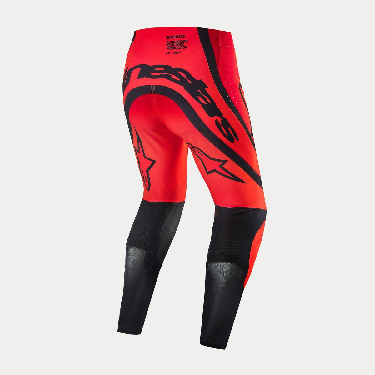 Alpinestars Supertech Ember LE-byxor, motocrossbyxor, Red Fluo och Bright Red med svarta detaljer, sedda bakifrån med framträdande svart Alpinestars-logotyp över sätet, stjärnlogotyper på låren och tekniska meshpaneler på underbenen.
