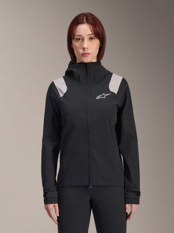 Alpinestars Stella A-Dura Rain Jacket, Women's Cycling Rain Jacket, Black with light gray shoulder panels, hooded technical shell with white logo on chest, adjustable Velcro cuffs, professional gear for MTB and wet weather riding