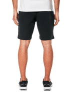 Alpinestars Dunker Shorts, svarta träningsshorts i fleece sedda bakifrån, bakficka med passpoal, Ageless-logotyp på bakhöften, bekväm passform, bärs med svarta sportskor och vit tröja