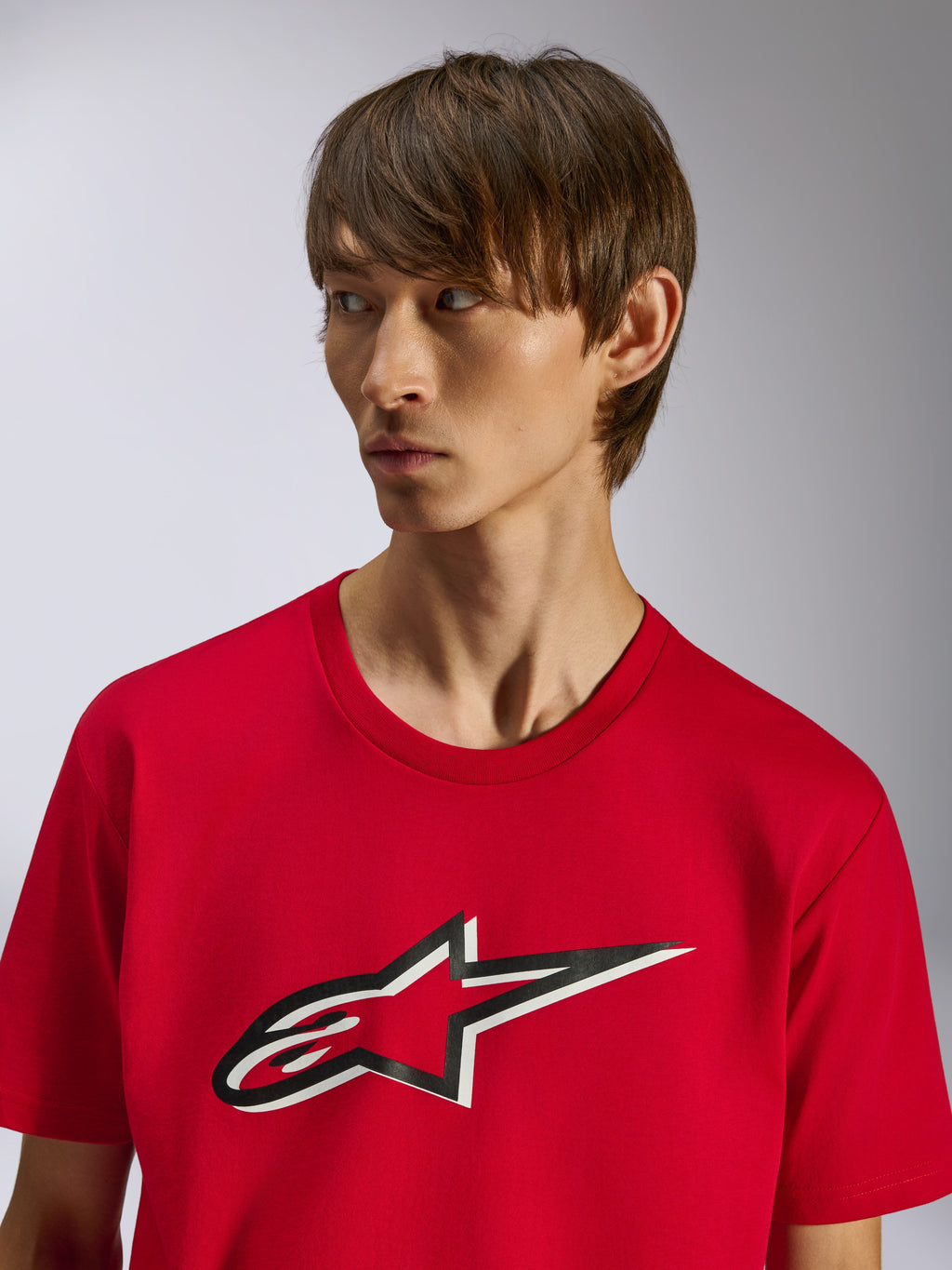 Alpinestars Ageless Shadow CSF T-shirt, kortärmad tröja, röd, Ageless-stjärnlogga framtill med svart och vit skuggeffekt, bärs av en modell, avslappnad motorsportinspirerad design