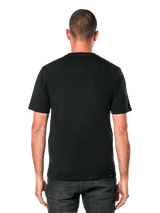 A person stands facing forward, wearing the Alpinestars Ride 4.0 Camo CSF Tee. The black T-shirt features a soft hand print with a colorful graphic logo and the word "RIDE" beneath. The person has short hair and a neutral expression. The background is plain black.