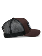 Alpinestars Heritage Patch Trucker Hat, Brown and Black, featuring a structured crown with a large embroidered patch, curved bill, and black mesh back, casual motorsport-inspired design