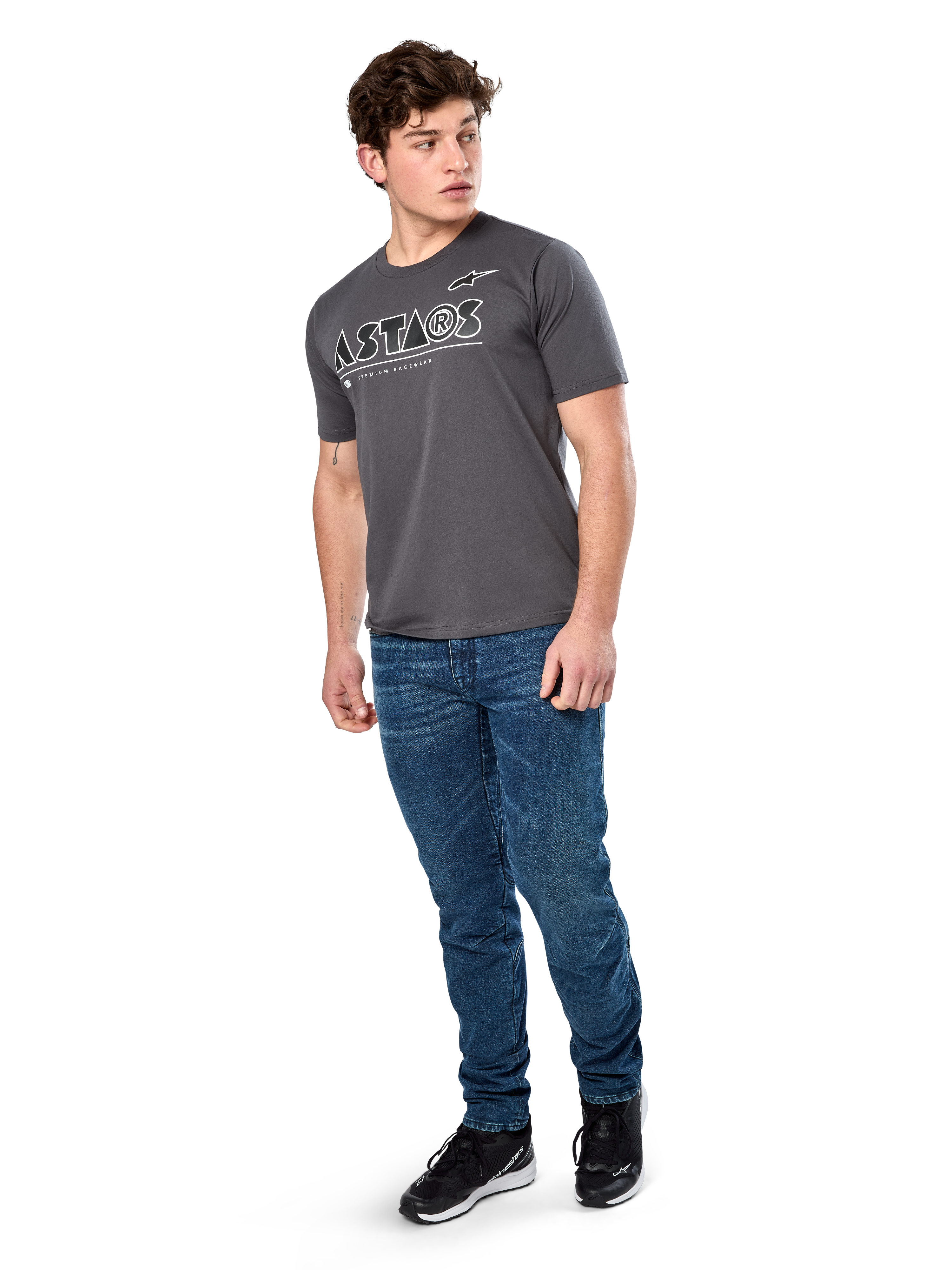Alpinestars Cereal CSF Tee, Short Sleeve T-Shirt, Charcoal, White Geometric Astars Text Logo, Casual Motorsport Streetwear worn with blue jeans and black sneakers