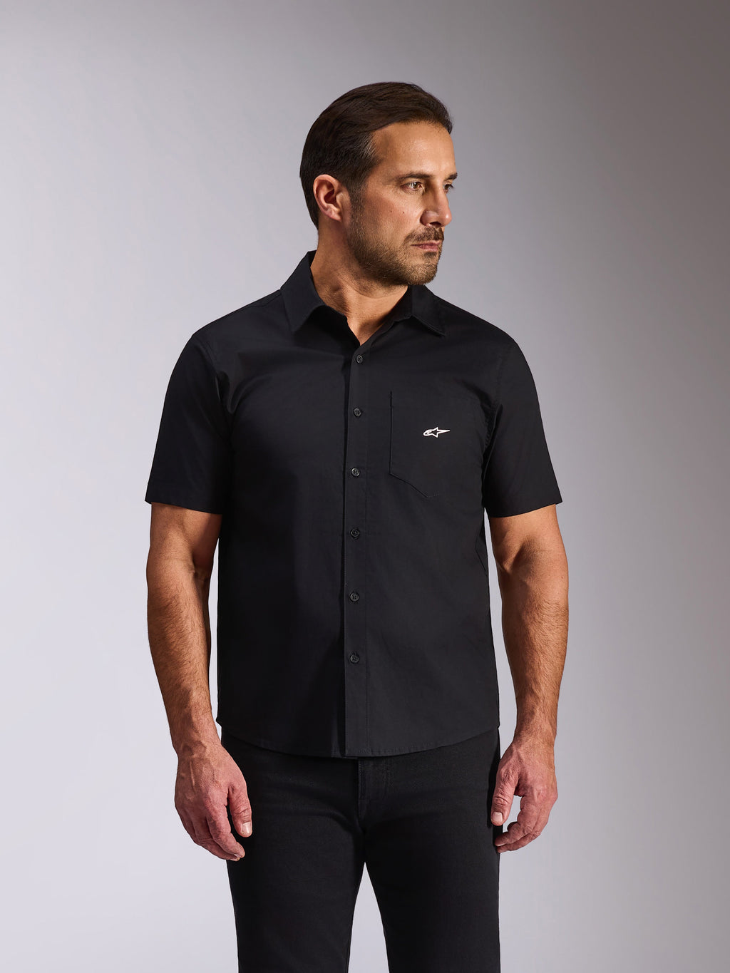 Alpinestars Strive Woven-skjorta, kortärmad button-down-skjorta, svart, vit Alpinestars-logotyp på bröstfickan, casual motorsport-streetwear