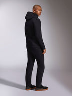 Alpinestars Ellipsoid Hoodie, svart casual streetwear, vy bakifrån på manlig modell, huvtröja i fleece med ribbade muddar och fåll, bärs med svarta byxor och sneakers, modern motorsportinspirerad design