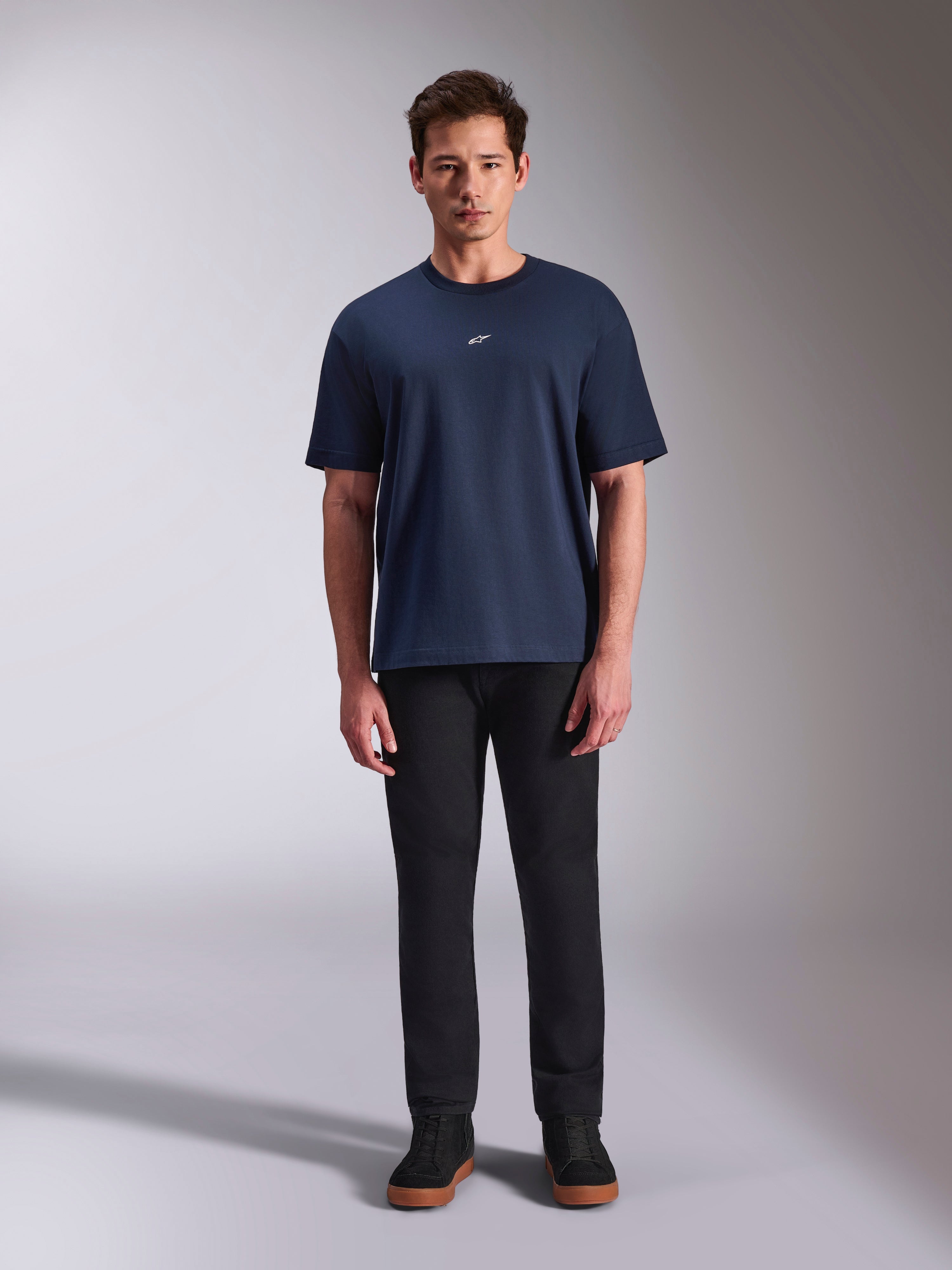 Alpinestars Focused Oversized CSF Tee, Short Sleeve T-Shirt, Navy Blue, small white Astars logo on chest, oversized fit, paired with black pants and black sneakers, casual motorsport streetwear