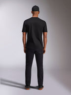 Alpinestars Plate CSF Tee, Short Sleeve T-Shirt, Black, back view on model, worn with black cap and pants, casual motorsport streetwear