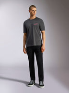 Alpinestars Pop Helmet CSF Tee, Short Sleeve T-Shirt, Charcoal Gray, featuring a pink Alpinestars logo on the chest, worn by a male model with black pants and sneakers, Casual Motorsport Streetwear