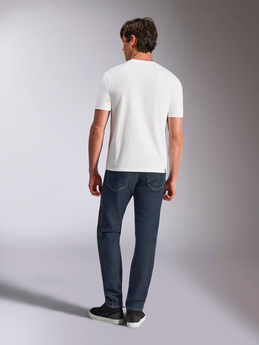 Alpinestars Abus CSF Tee, Short Sleeve T-Shirt, White, rear view of model wearing white tee with dark denim jeans, casual motorsport-inspired streetwear