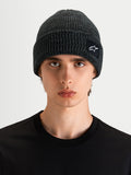 Alpinestars Unload Rib Cuff Beanie, sportswear knit beanie in charcoal melange, worn by a model, featuring a rib-knit design and SAstars woven patch logo