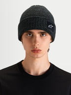 Alpinestars Unload Rib Cuff Beanie, sportswear knit beanie in charcoal melange, worn by a model, featuring a rib-knit design and SAstars woven patch logo