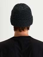 Alpinestars Unload Rib Cuff Beanie, sportswear winter hat in charcoal melange, back view on a model showing knit jersey stitch construction and fold-up cuff