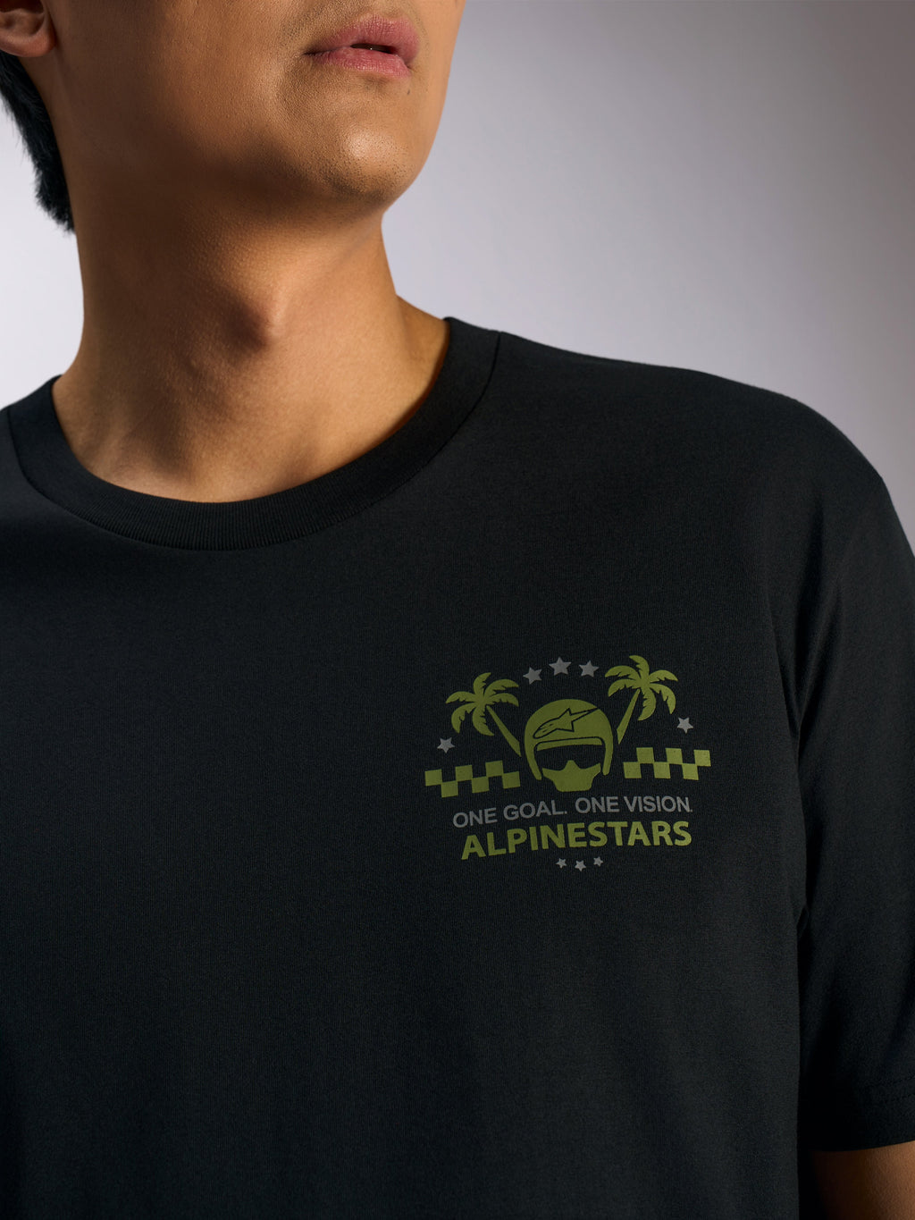 Alpinestars Order CSF Tee, kortärmad t-shirt, svart, olivgrön grafik med hjälm och palmträd på bröstet samt texten 'ONE GOAL. ONE VISION.', avslappnad motorsport-streetwear