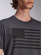 Alpinestars Waving CSF Tee, kortärmad t-shirt, charcoal, med en svart flaggrafik med stjärnlogotyper på bröstet, avslappnad motorsport-streetwear