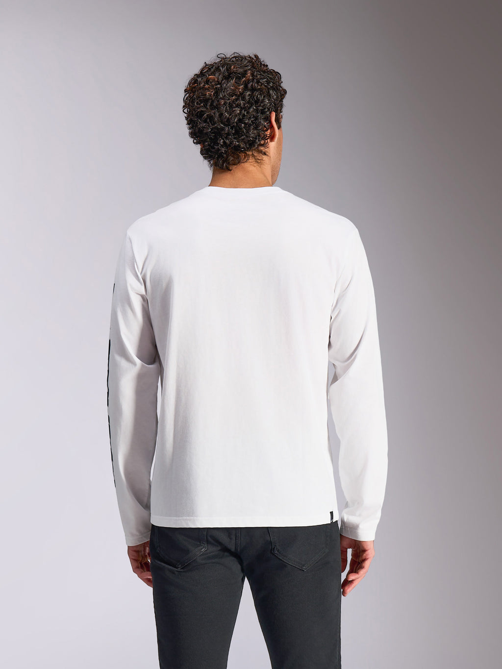 Alpinestars Trackside CSF Tee - Long Sleeve, White, back view on model, paired with black pants, clean white fabric with long sleeves, casual motorsport-inspired streetwear