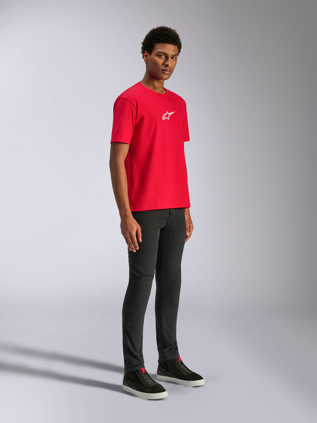 Alpinestars Frontal CSF Tee, Short Sleeve T-Shirt, Red, white star logo on the chest, worn by a model with black pants and black sneakers, casual motorsport performance streetwear