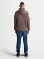 Alpinestars Camino Textured Oversized huvtröja, brun taupe, herrhoodie sedd bakifrån på modell. Konstruktion i texturerad stickad twillfleece med ribbade muddar och fåll för en avslappnad och sportig look.
