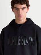 Alpinestars Shaw Oversized Hoodie, Black Pullover Sportswear for Men and Women, featuring a tonal textured word logo on the chest, relaxed oversized fit, made from soft cotton blend fleece with a self-lined hood.