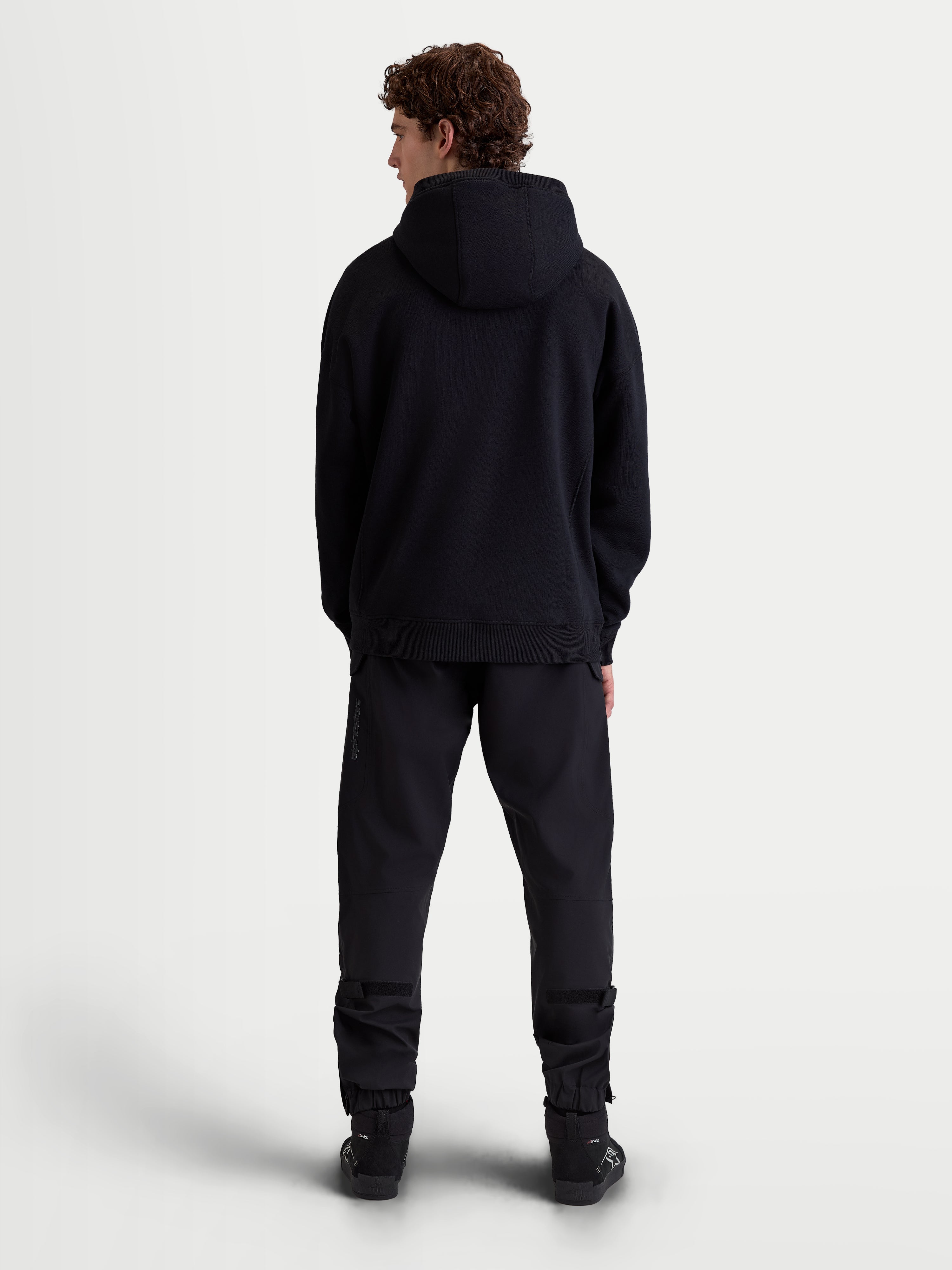 Alpinestars Shaw Oversized Hoodie, Black Casual Sportswear Pullover, Full-Length Back View on Model, Relaxed Silhouette with Self-Lined Hood and Ribbed Trims, Soft Fleece Construction.