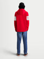 Alpinestars Cubic huvtröja, herr-sportswear-huvtröja i fleece, sedd bakifrån på modell, röd och vit med färgblockerade ärmar, mjuk bomullsblandning.