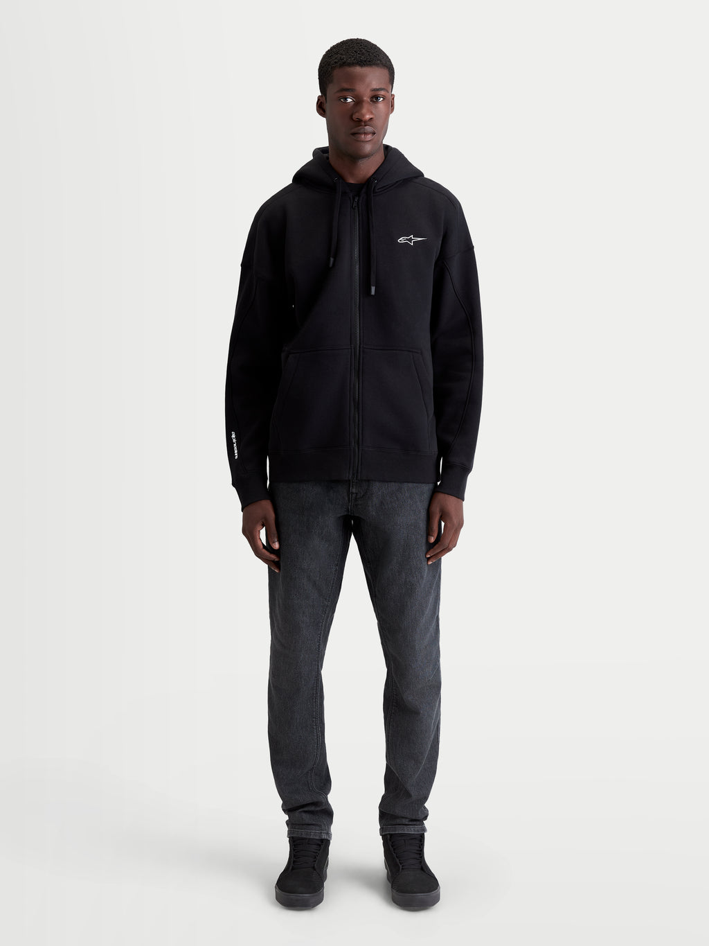 Alpinestars Entity Oversized Hoodie, Premium Sportswear Zip Fleece, Black, Unisex Relaxed Fit Apparel with Vislon Front Zipper, Self-Lined Hood, and Kangaroo Pocket, Cotton-Recycled Polyester Blend with Embroidered Logos, Full Body On-Model View.