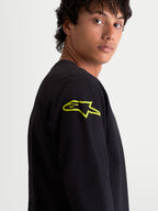 Alpinestars Velocifier CSF långärmad t-shirt, motorsportinspirerad sportswear för herrar, svart med gul Astars-logotyp på axeln, närbild